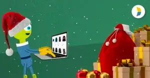 alien on computer and a pile of gifts, representing strategies for ecommerce peak season success