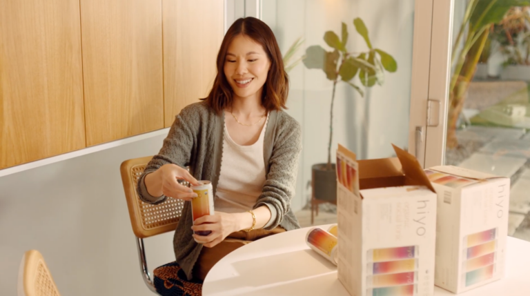 woman opening a can of hiyo